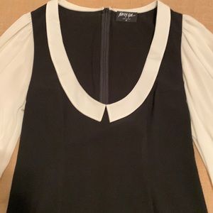 Black mini dress with ivory chiffon sleeves.